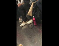 Man wears white and brown loafer crocs on subway train 