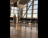 Man tiktok dance beside chairs at airport