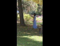 Woman in blue dress selfie at the park