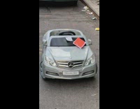 Mini toy Mercedes car parks on the street and gets a red ticket on windshield