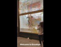 Woman in nude one piece dances at storefront