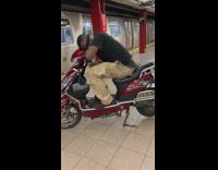 Black shirt guy sleeps red motorcycle subway 