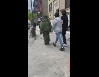 Guy Walks Down Sidewalk in Grassy Costume 