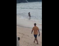 Man with mask walks at the beach