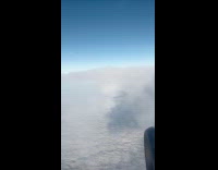 Rainbow around shadow of airplane on clouds