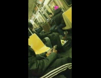 man opens black suitcase in subway