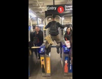 Guy kneels on subway gate