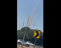 Submitter sees dust devil while driving at highway