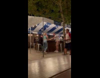 Woman rolls on ground for guy attention