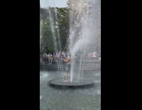 Guy spins stick in fountain 