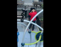 Guy red jacket shaves head at park