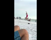 Woman red onesie jump all direction beach