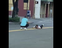 Blue shirt guy touches toes pose street