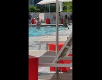 Old man take pictures girl in pool bikini