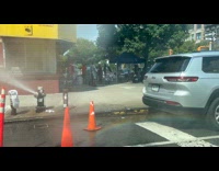 Rainbow on street from open fire hydrant water
