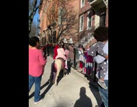 Little girl rides white pony outside apartment 