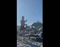 Girl lay bed drink straw cup  beach