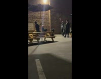 Guy sits poses hay bale black shirt