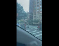 Person crosses street in stilts 