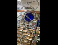 Blue ball between metal spirals moves down 