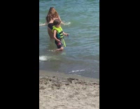 Blue bikini girl splashes beach water kids 