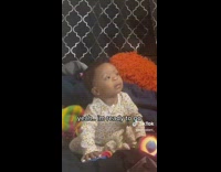 Curious Kid Shakes Head as Lady Dances