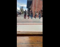 Five people dance video shoot outside restaurant