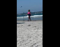 Collab IITW - Woman pink tube top dances at beach