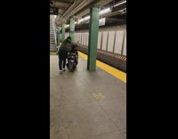 Guy push motorcycle with flat tire subway