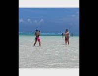 Woman in a bikini jump shot on the beach shore