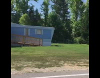 Guy drives through trailer park and sees giant leg sculptures heels wooden