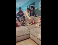 Parents trying to get babies to take friendmas photos