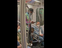 Man on Subway Holds Black Boy Doll 