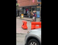Woman poses and lean on street pole