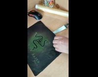 Person remove mouse pad stuck on desk