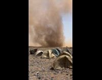 Sandstorm near the tents on the field
