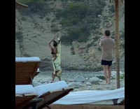 Woman robe bend backwards arms stretched beach