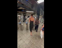 Tall woman casually walks over subway turnstile