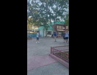 Man in white shirt and a cap poses inside the park