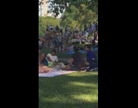 Three people tiktok dance in the middle of the picnic