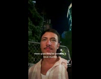 Line of people dancing behind news reporting 