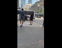Man crossing street with dog on shoulders