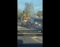 Tow truck towing SUV that is skidding wheels on road