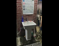 Purple lube bottle on white sink outdoors 