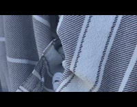 Black shorts guy resistance band beach sand