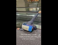 Guy hanging pulled by escalator with backpack