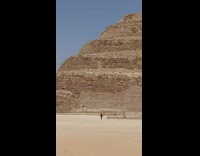 Man run on the desert sand with a selfie stick