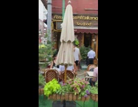 Guys move green couch during italian street festival