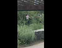 Woman in crop top tiktok dance near the bushes