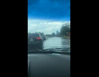 Collab winy - Filmer in car driving through flooded road